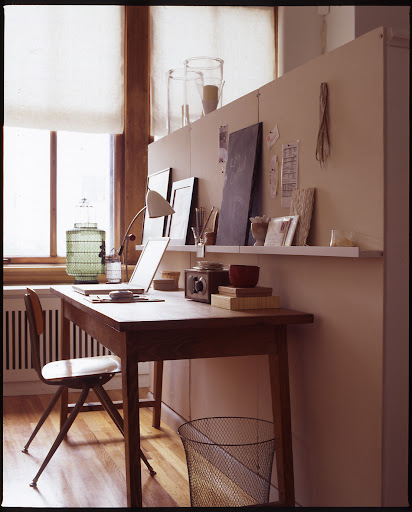 Desks are other places that accumulate clutter easily.  A small picture ledge hung above is perfect for keeping accessories in reach and off your work surface.