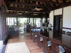 Inside the main lodge - indoor dining area in the foreground, in the background on the left is a lounging area and the bar and on the right is the "port around the fireplace on a cold winters night" area.