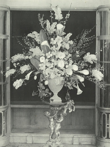 Spry created this lovely platformed arrangement for a church wedding with white and yellow forsythia, lilac, tulips, hyacinths, narcissi and arums with a few sweeping trails of ivy. She explains how the arranged but not forced lines create a defined and dignified arrangement.