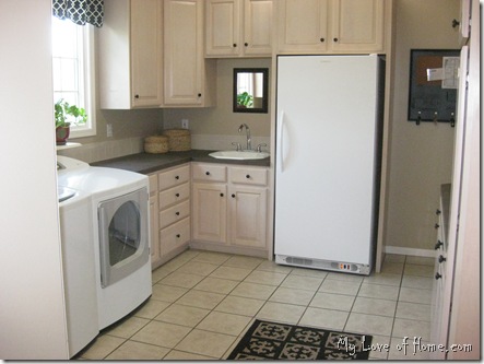 beige black laundry room white washer dryer black rug