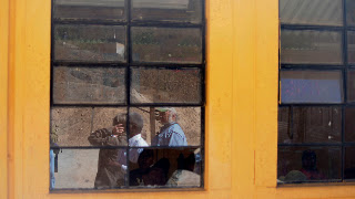 Susan, Eddie and Marty reflected in the windows from the first Sienna Project   school in Aqua Viva Canton, Guatemala. Photos by TOM HART
