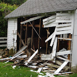 Tearing off the siding, so that the garage can be pulled down