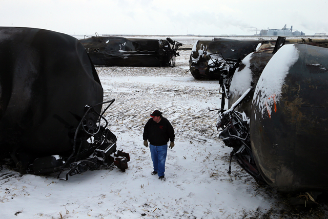 Ed McConnell, the mayor of Casselton, N.D., inspects the burned oil tank cars after a fiery rail accident in December 2013 only a half mile down the tracks, which prompted residents to evacuate the town. Photo: Jim Wilson / The New York Times
