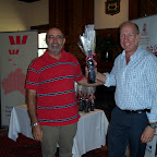 Fred Hamood presenting the 'nearest the pin' prize of O'Leary Walker Wine to John Easling