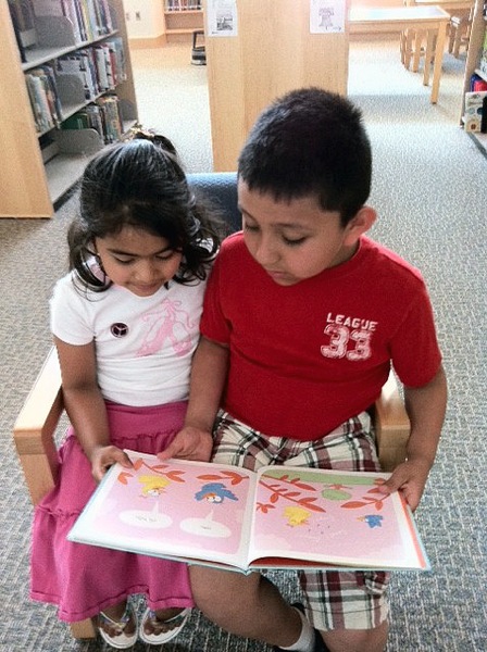 Nephileen and Jaderson read from one of the over 40 books donated