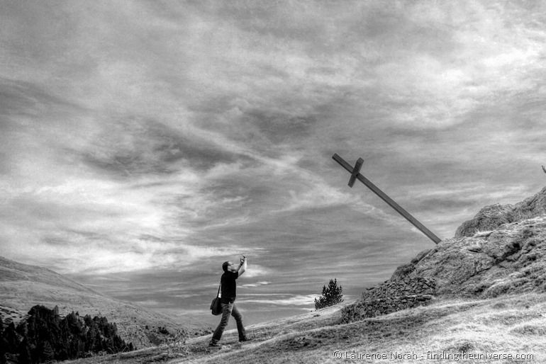 man and cross Nuria valley pyrenees spain
