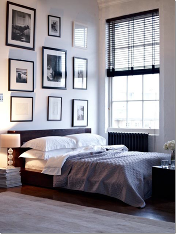 Gallery Walls: Keeping Them in Place monochromatic gallery wall adds focal point in modern bedroom