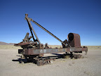 The remnants of an ancient steam crane. Now just parked out in the desert near the cemetery.