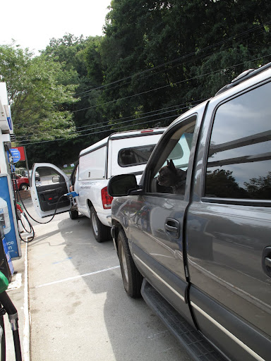 So that's how you pump gas.  I'll just follow that white truck's lead and put that hose into the gas tank.