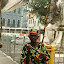 He is playing a Berimbau, a popular Capoeira musical instrument.