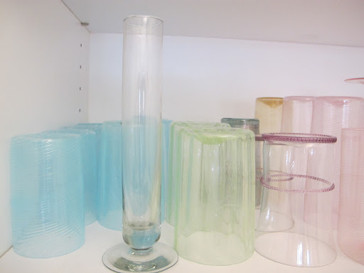 Ayesha collects venetian glasses and keeps them at the ready on shelves in her office.
