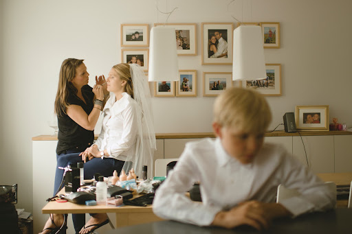 After getting her hair done (and affixing her cathedral-length veil to her head), the bride returned to her parents' condo to get her makeup done by Maria, who is the brand manager of MAC Cosmetics in Iceland.