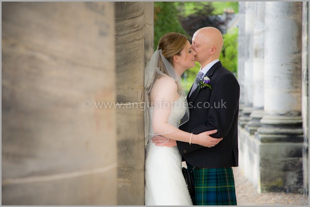 Bride and groom at the pillars of dollar academy scotland