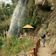 Lynette trooping towards the waterfall from earlier, bottle of Timotei in hand.