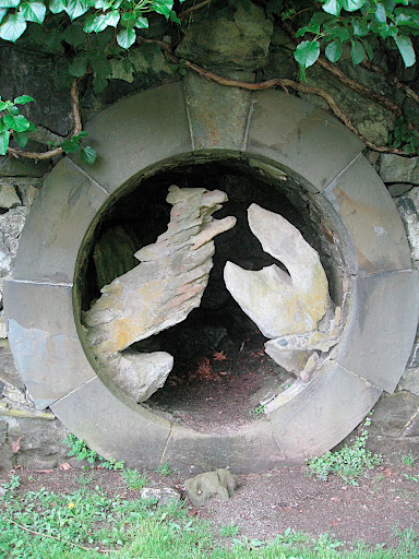 The grotto - an element of Italian Renaissance gardens - combines with a round Chinese moon gate and very sculptural stones to create a completely unique feature that feels classic and contemporary at the same time.