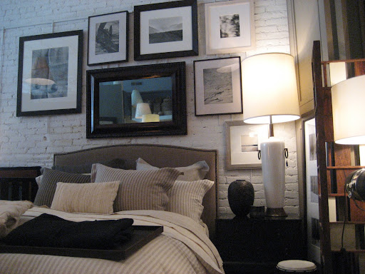 Lots of great framed photography hang on the painted exposed brick walls.