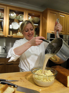 To make bread pudding, Nancy makes a custard on the stove and then pours it over the diced brioche. The liquid gets soaked up by the bread and is then popped into the oven with additional chocolate pieces sprinkled on top.