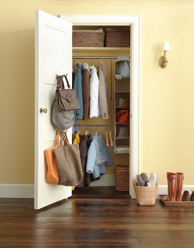 This entry way has a a Double Hang Closet Rod ($9.99 from The Container Store) -- it provides the perfect extra space to hang double the amount of coats your closet usually can store. Extra hooks on the door come in handy for hand-bags and hanging scarves.