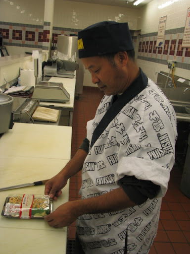 Ngun with a finished package of sushi in Price Cutter. Ngun makes sushi for the store to support his family and help several other families in Springfield who came to the United States from Myanmar as refugees.