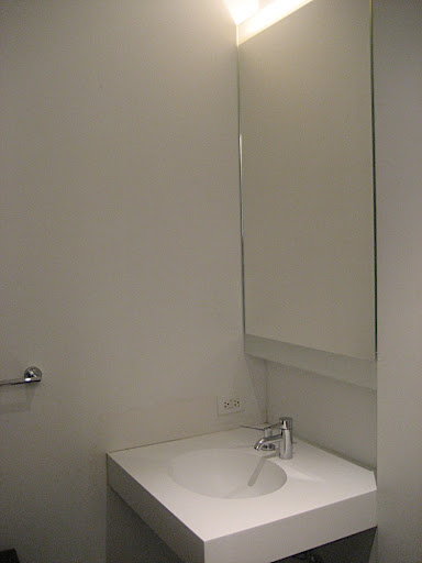 The powder room has built in lighting behind the medicine cabinet mirror.