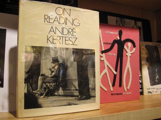 A few books located behind the cash register.