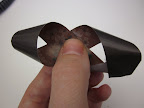 Next you fold and tape together the loose ends to make a figure eight shape. If you want triangles to hold their shapes at the ends, just press them down a little to get a crease.