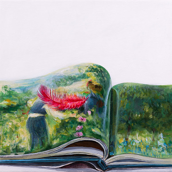 Red feather on book