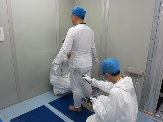 Workers at the Fukushima Daiichi nuclear plant are scanned for radiation before entering the Hitachi/GE rest area, June 2011. TEPCO