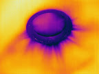 This recessed light fixture clearly shows streaks of hot attic air leaking into the air conditioned living space. Replacement of the recessed light to an insulation compliant light or installation of a Tenmat High Hat Cover will solve the problem.