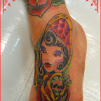 Doll tattooed on the foot with a rose and skull - tattoo meanings