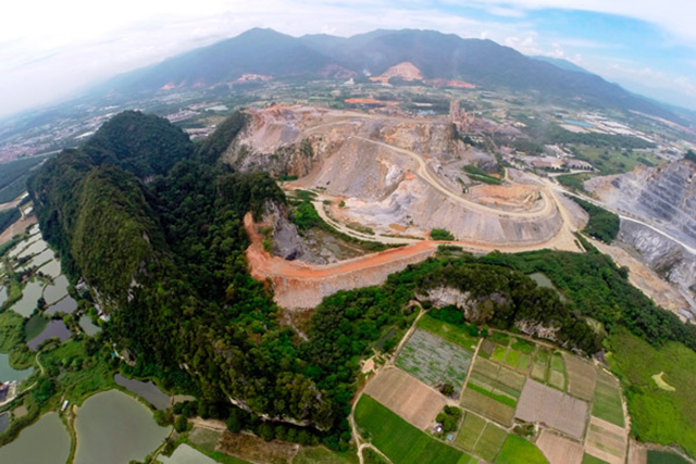 Aerial view of cement quarry and limestone hill in Malaysia, owned by international company Lafarge, that is home to a number of species found nowhere else, including a new snail. Photo: Ong Poh Teck / Basteria