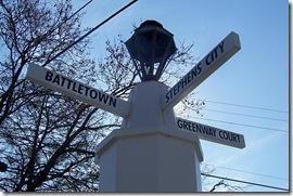 Directional signs on top of White Post column