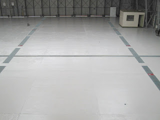 Aircraft Hangar Floor. The old paint system on this floor was completely removed by Ultra High Pressure Water Jetting. The floor, some 2200 metre squares, was then painted with 3 coats of  High Build Epoxy.