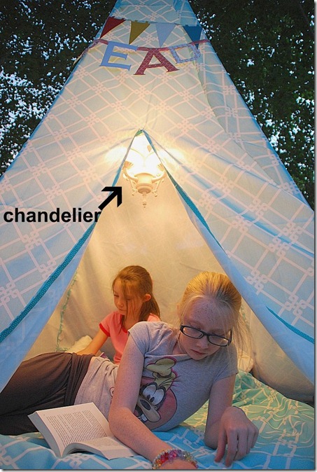 reading teepee tent at night with chandelier
