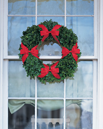 The shiny green foliage of a boxwood wreath embellished with a quartet of slim satin bows captures the classic Christmas pairing of red and green. This window wreath could just as easily adorn a door or wall to make a festive statement. The shiny green foliage of a boxwood wreath embellished with a quartet of slim satin bows captures the classic Christmas pairing of red and green. This window wreath could just as easily adorn a door or wall to make a festive statement.