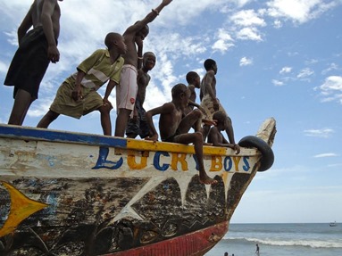 Children gather on a fishing boat in Ghana