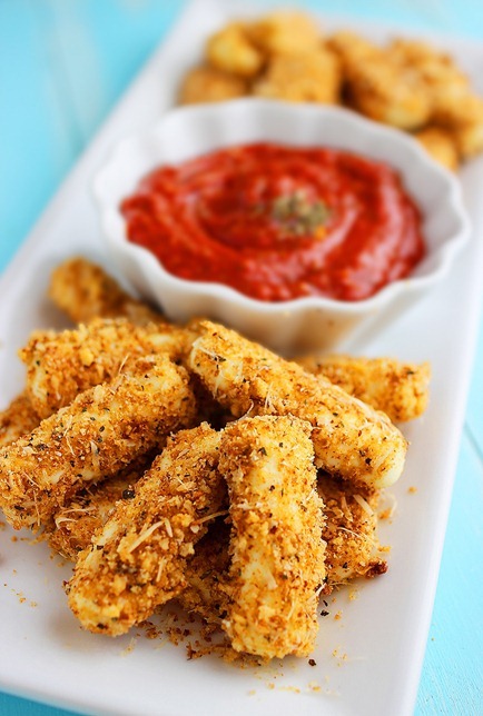 Skinny Baked Mozzarella Sticks – Everyone's favorite indulgence made skinny! Ooey gooey mozzarella sticks hot out of the oven = snacking heaven! | thecomfortofcooking.com
