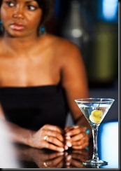 Woman at bar with martini