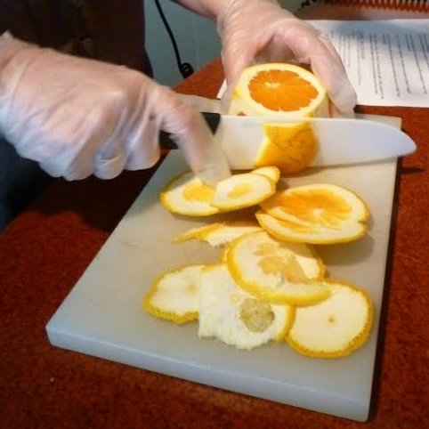 To properly slice an orange, you cut the skin and pith from the top and bottom first. Then from the sides, allowing your knife to follow the curve of the orange.
