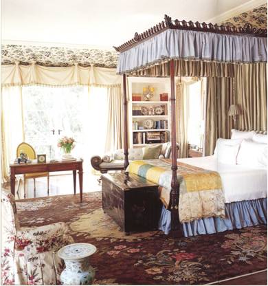 On the other end of the spectrum, this bedroom speaks to the English country-side with layers of patterns and textures and an ornate canopy bed.