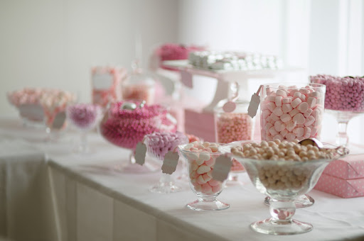 The candy bar, served later that evening, featured candies in various shades of pink labeled with tags and ribbons from Shop Sweet Lulu (http://shopsweetlulu.com/). It also served as favors, as mini polka-dot takeout boxes were provided.