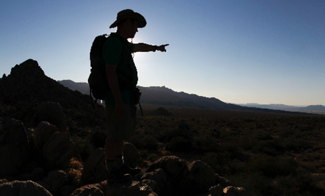 Seth Shteir, a field representative for the National Parks Conservation Association, points out features in the Mojave National Preserve near Kelso, Calif., in this 19 October 2011 photo. By tapping into an aquifer the size of Rhode Island under a 35,000-acre Cadiz ranch, proponents say they can supply 400,000 people with drinking water in a few years. Chris Carlson / The Associated Press
