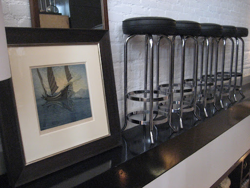 How crazy is this display of great, classic barstools and an old piece of art work.