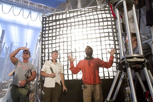 Makeup artist Charles Carter and first assistant director Jamie Marshall stand next to director Tarsem Singh as he mimics a reaction he wants from a performance, "Snow White," September 12, 2011