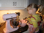 Helping put the flour in
