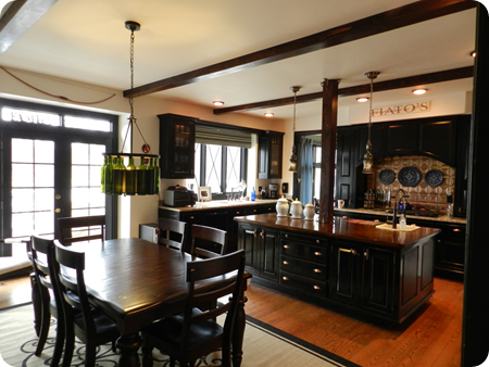 black cabinets wood beams kitchen