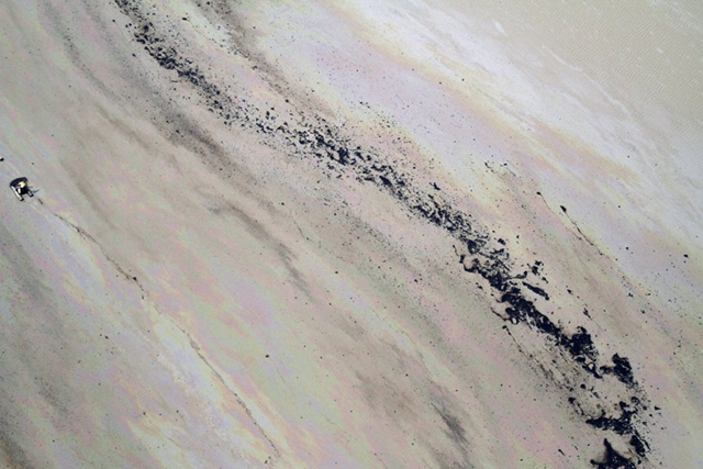 Aerial view of the tailings pond at the Athabasca tar sands mines, 18 May 2012. Most ponds are coated in a sheen of oil that can be deadly to waterfowl, like ducks and geese, that land on its surface. businessinsider.com