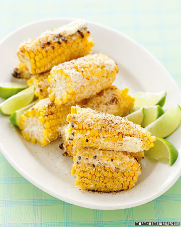 Grilled corn, flecked with chili and a cheesy buttery spread, takes an American classic south of the border. (marthastewart.com)