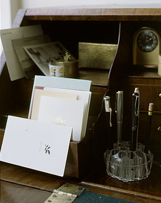 Here, a vintage floral frog is used as a pen holder.