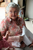 Nana opening her gift from Oscar